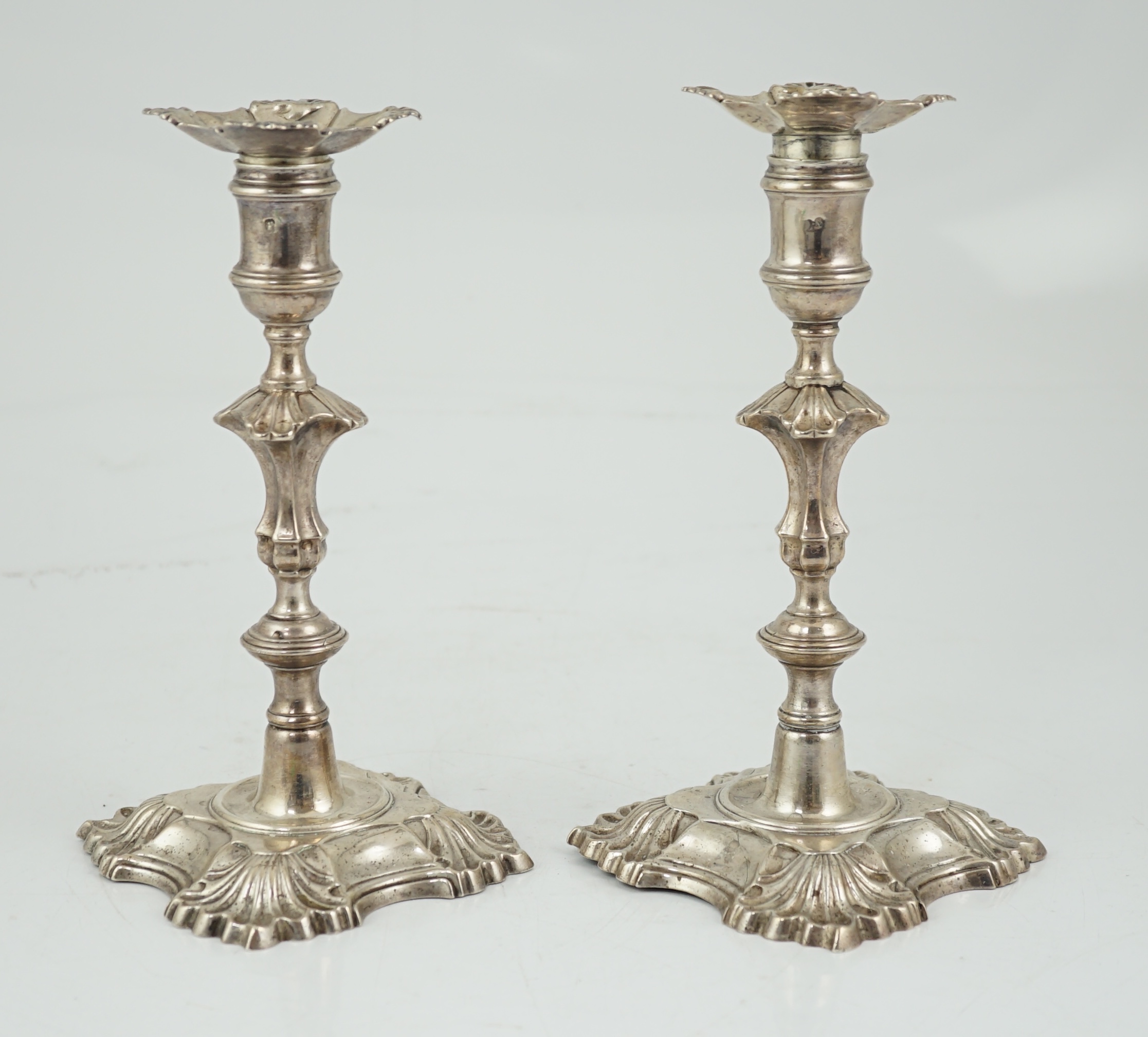 A pair of George II cast silver candlesticks by William Gould